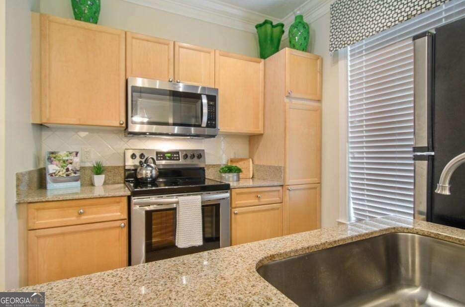 a kitchen with a sink a stove and refrigerator