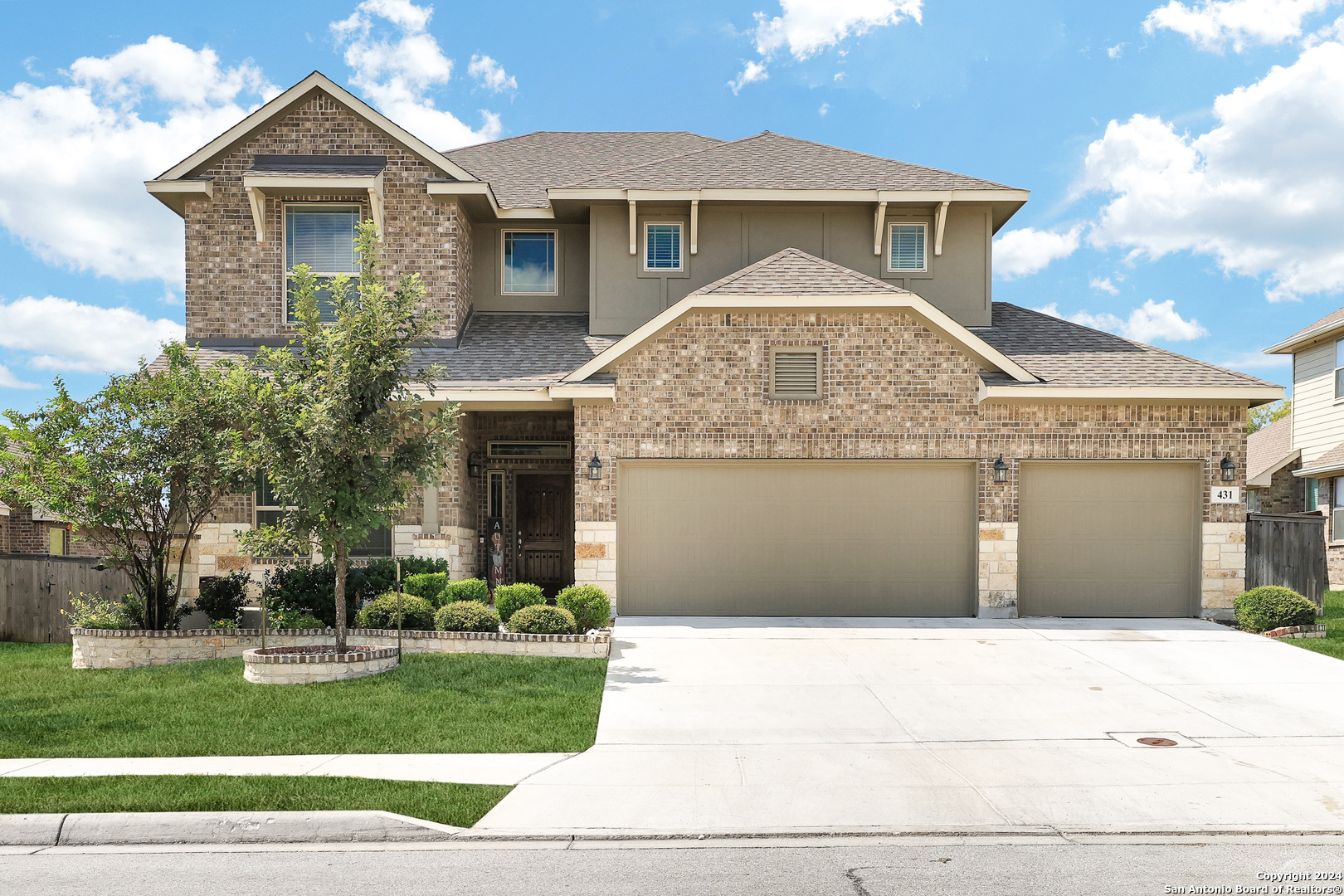 a front view of a house with a yard and garage