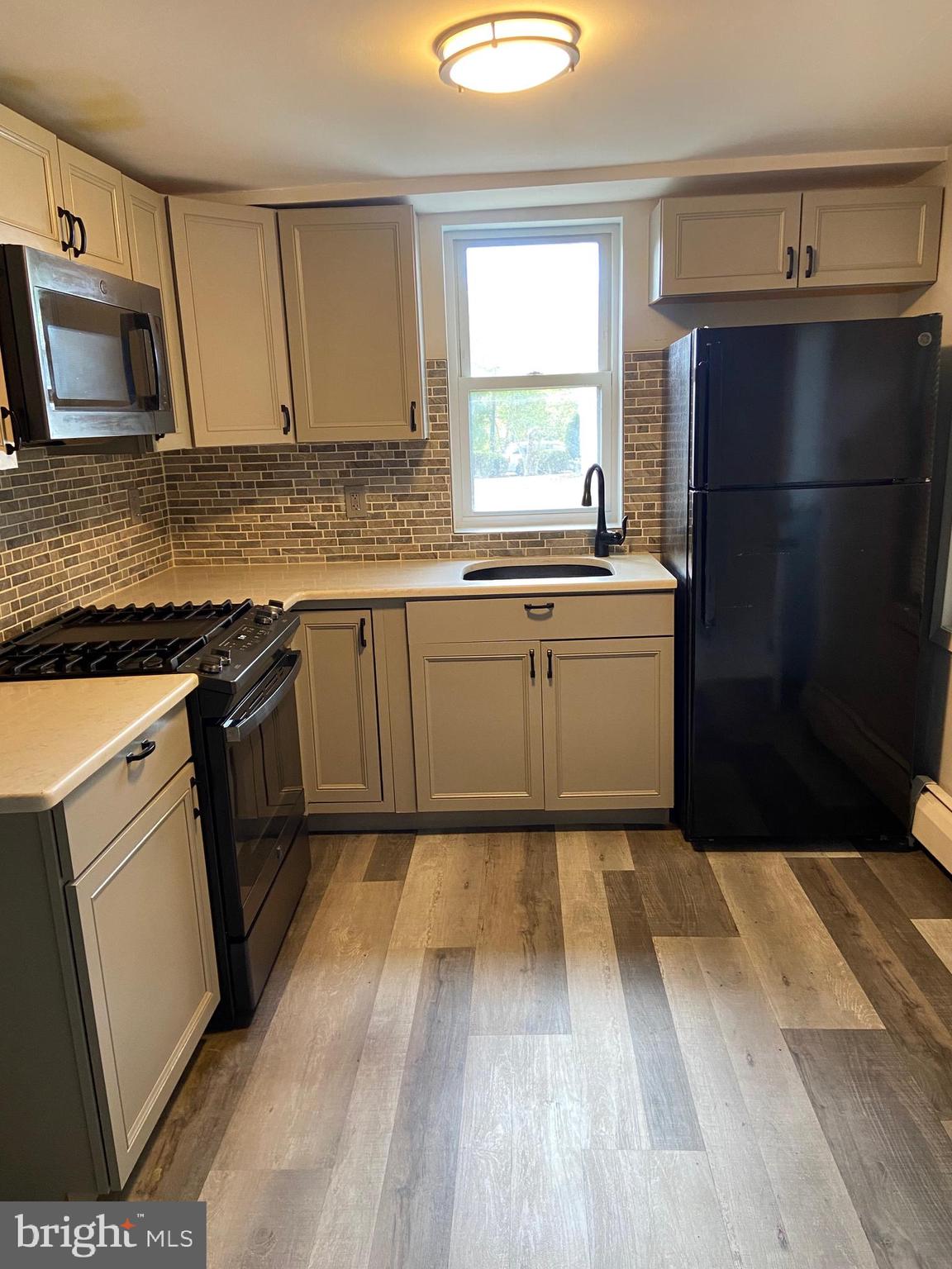 a kitchen with a sink stove and refrigerator