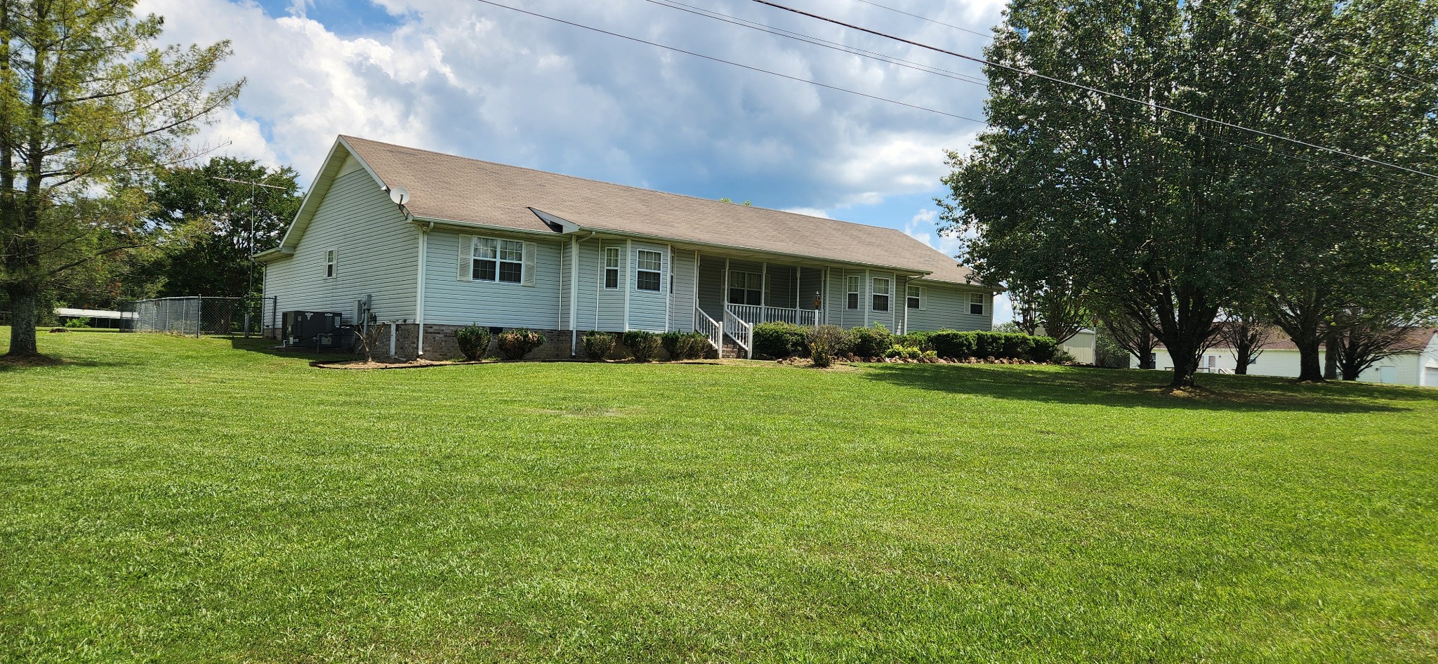 a front view of house with yard and green space