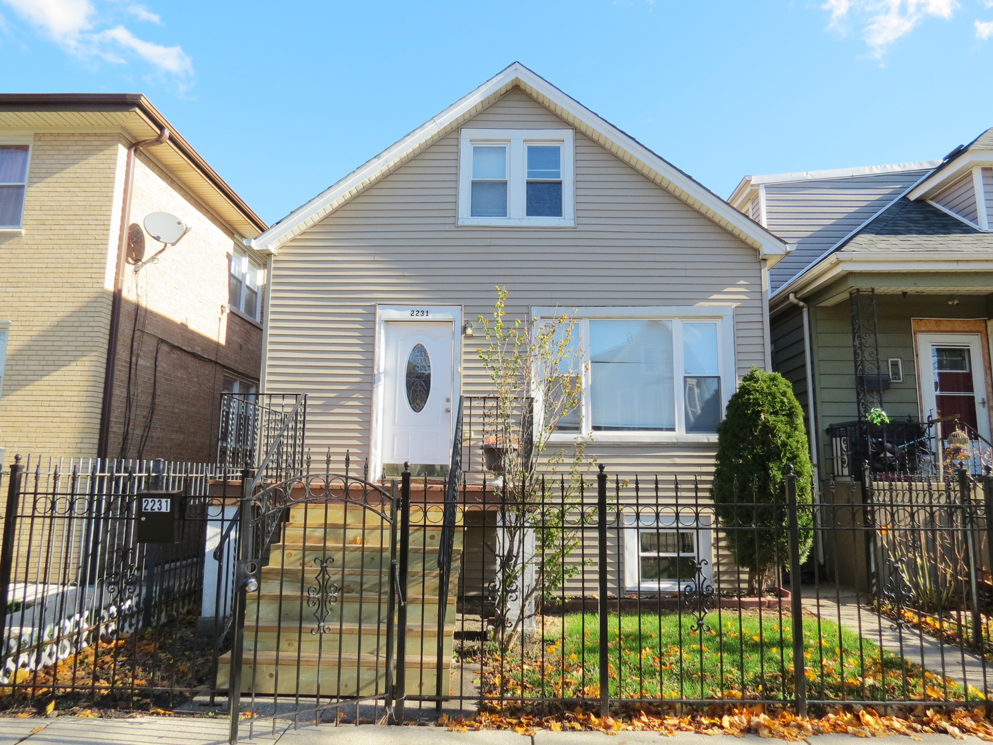 a view of a house with wooden fence