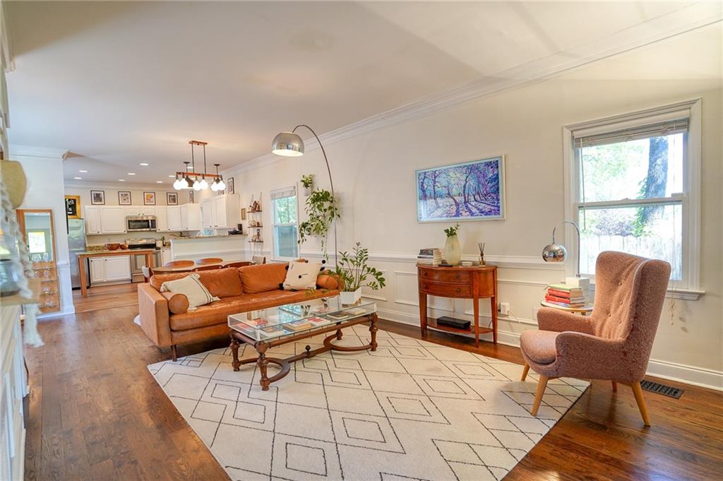 a living room with furniture and a table with wooden floor