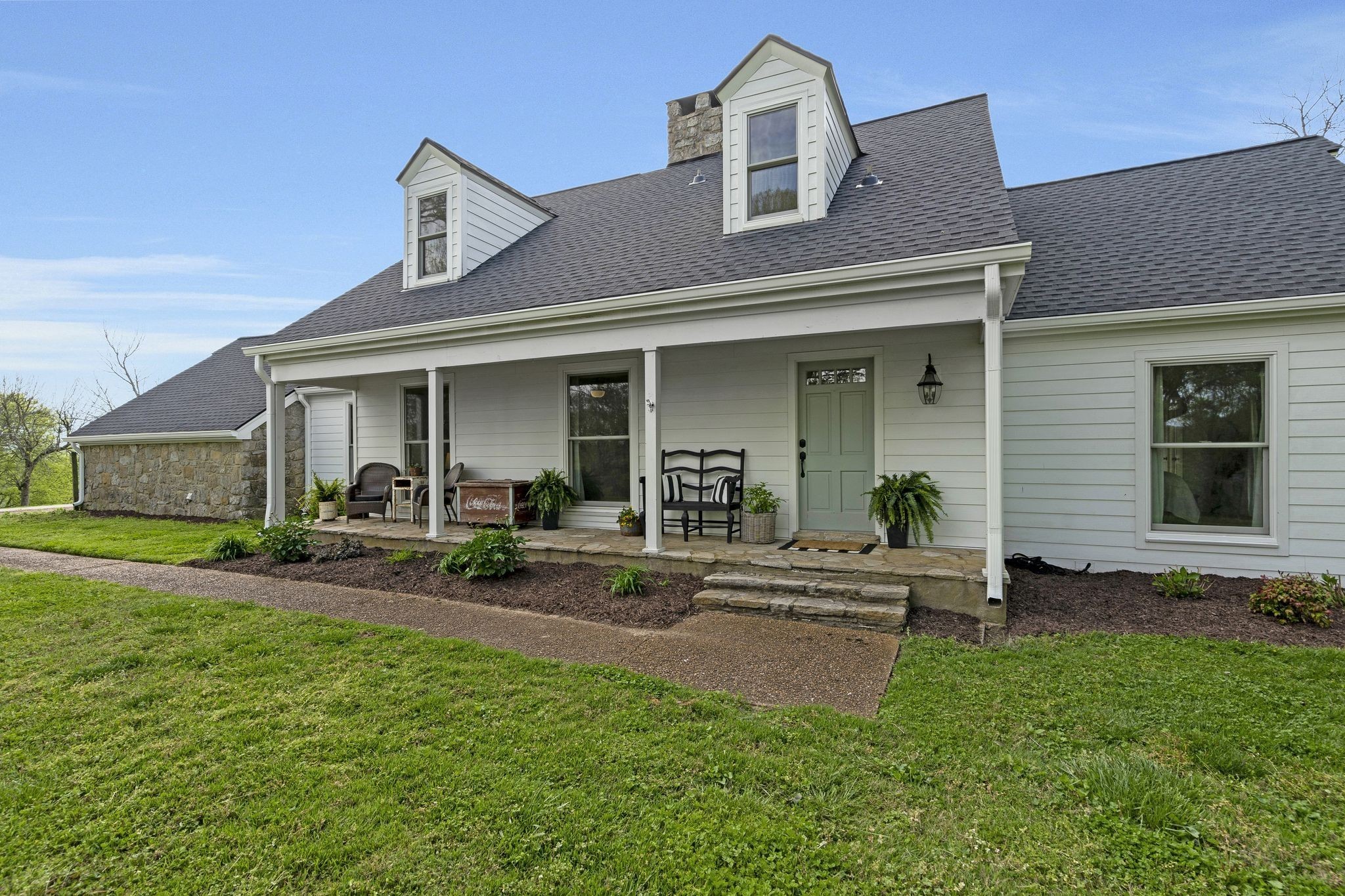 a front view of a house with a yard and porch