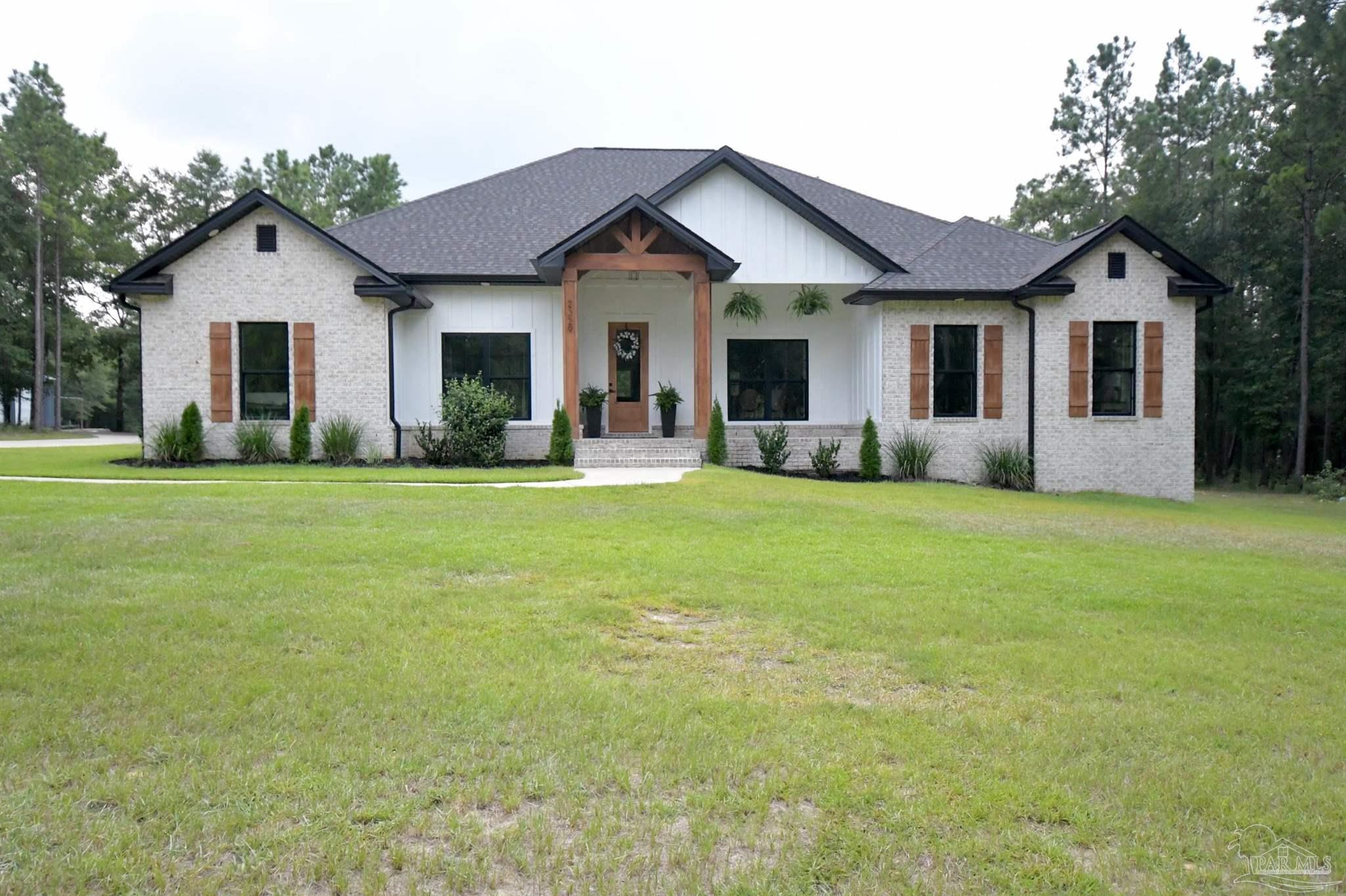 a front view of house with yard and green space