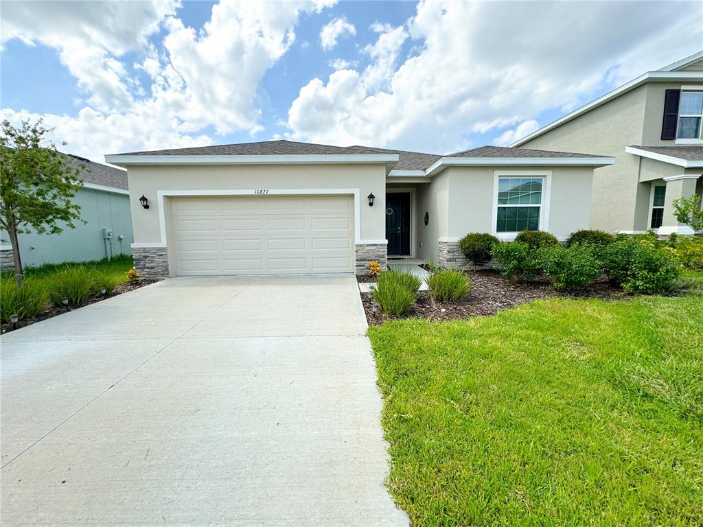 a front view of house with yard and green space