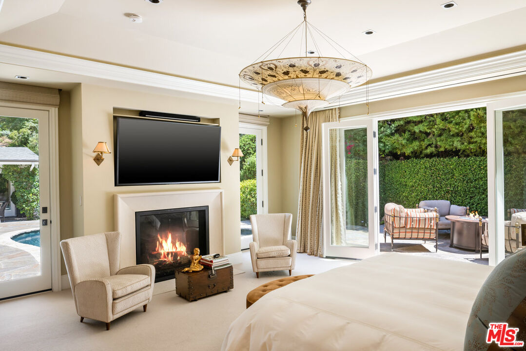 a living room with furniture fireplace and a large window