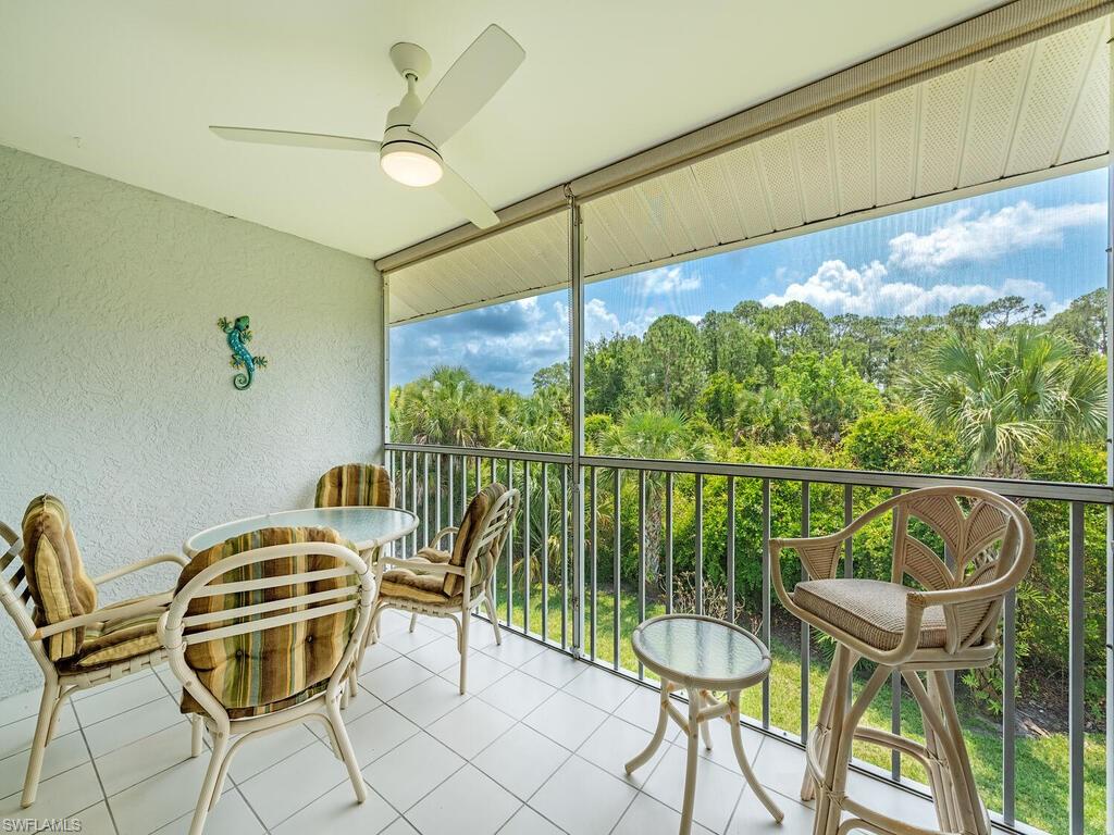 a balcony with table and chairs