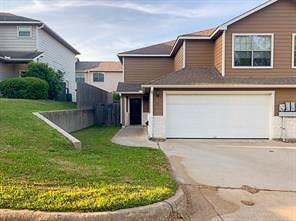 a view of a house with a backyard