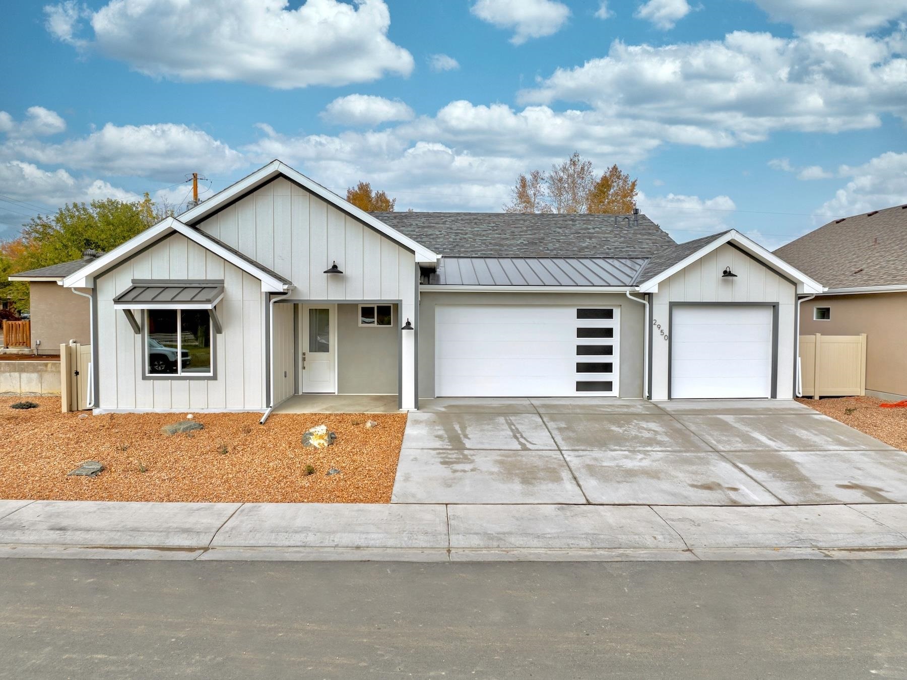 a front view of a house with a garden and garage