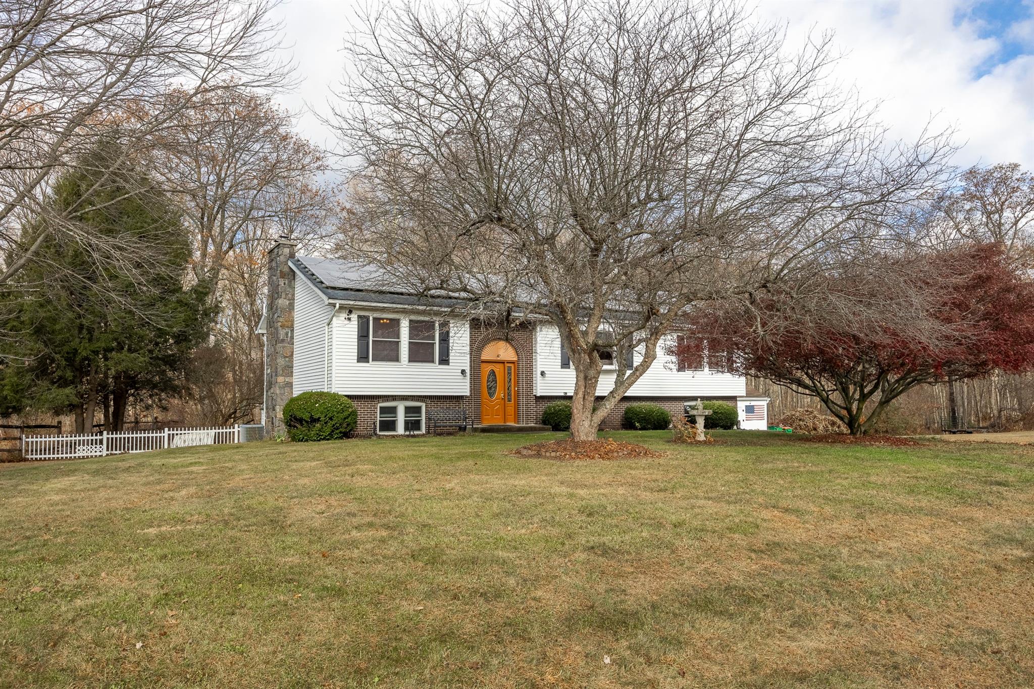 Raised ranch featuring a front lawn