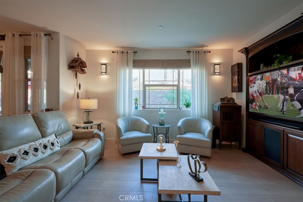 a living room with furniture a rug and a flat screen tv