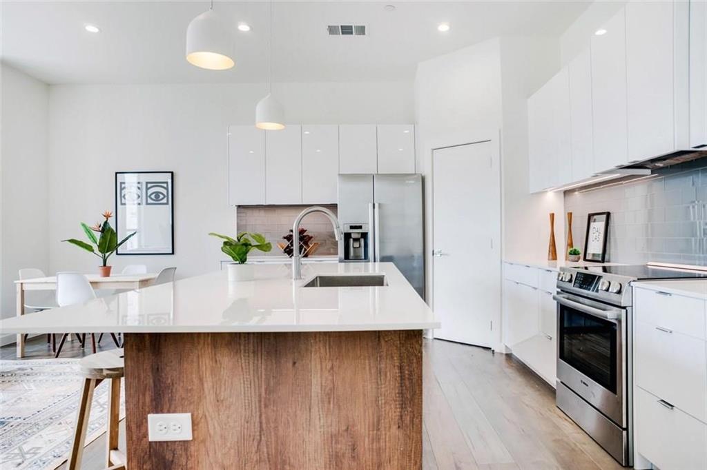 a kitchen with stainless steel appliances a counter space and cabinets