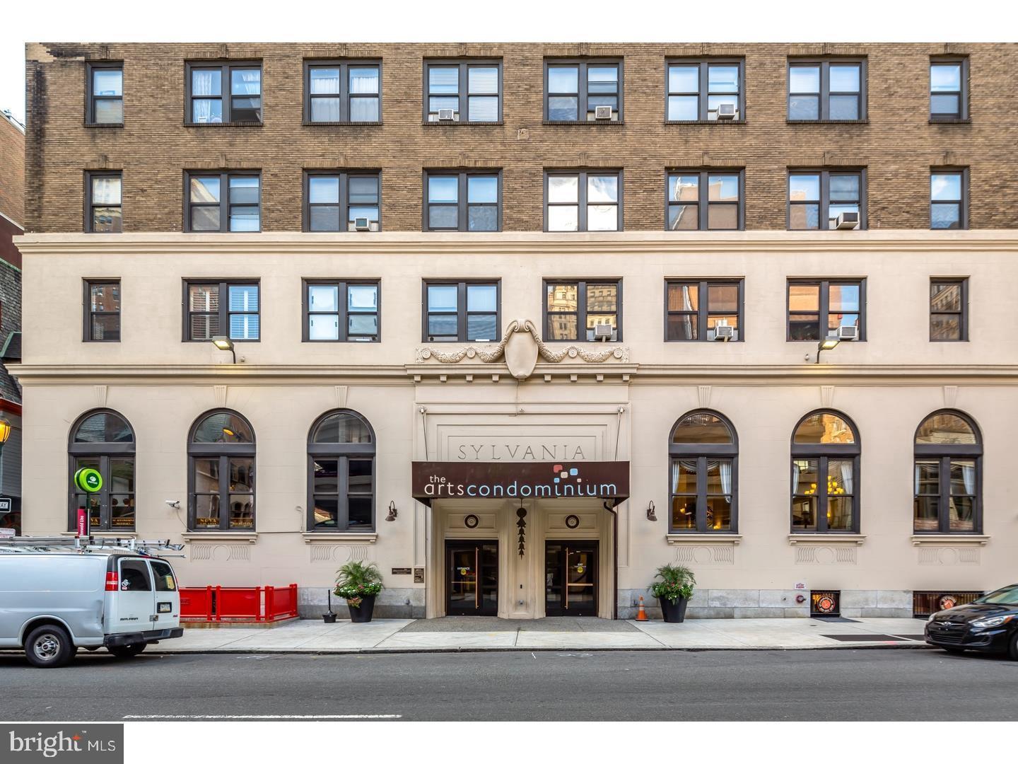 a front view of building with lot of cars parked