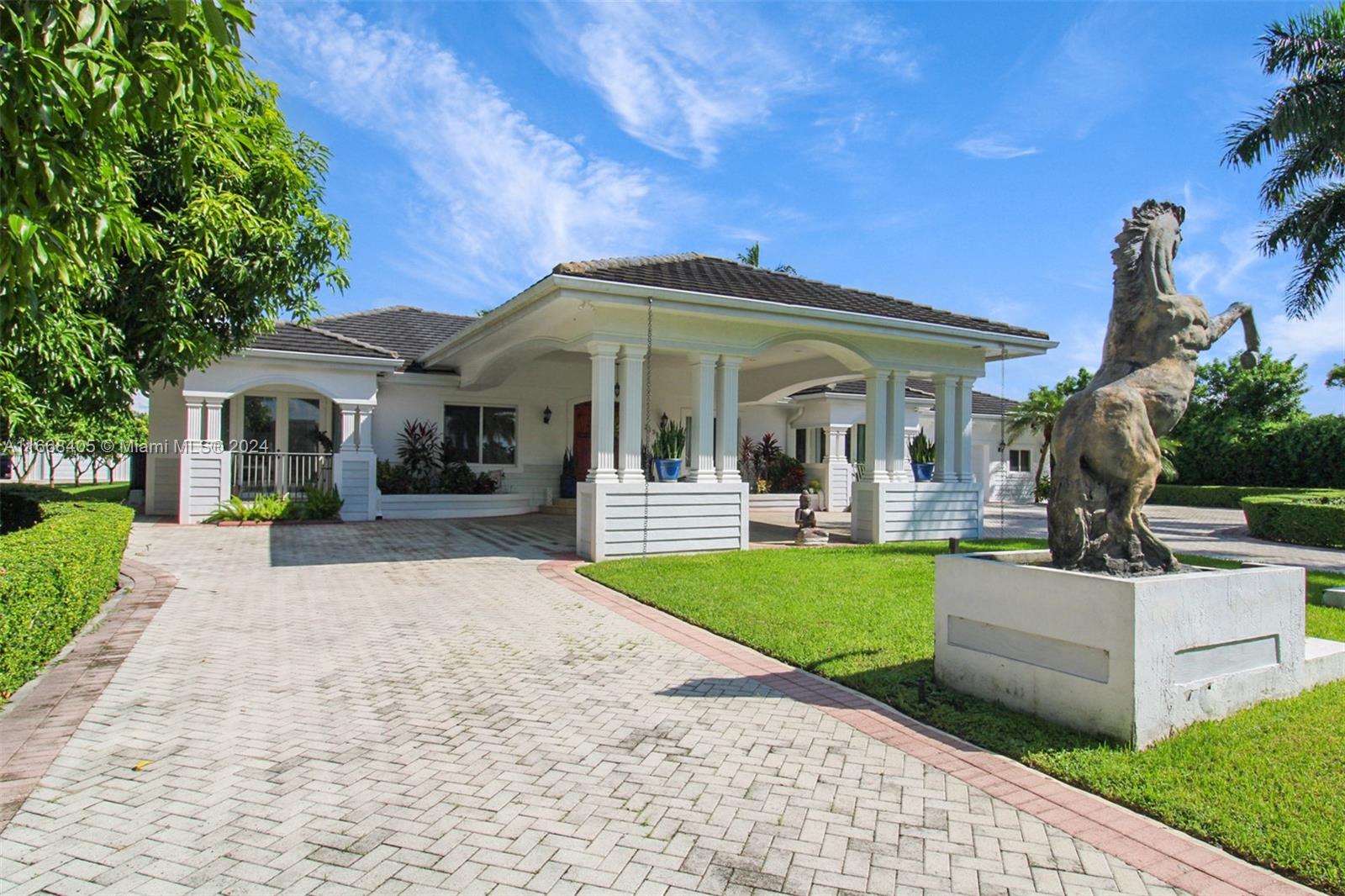 a view of a house with backyard porch and sitting area