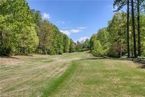 a view of a field with trees in the background