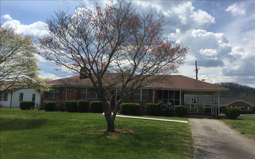 a front view of a house with a yard