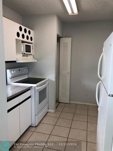 a kitchen with a stove a sink and a microwave