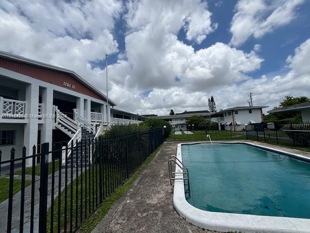 a view of a swimming pool with a yard