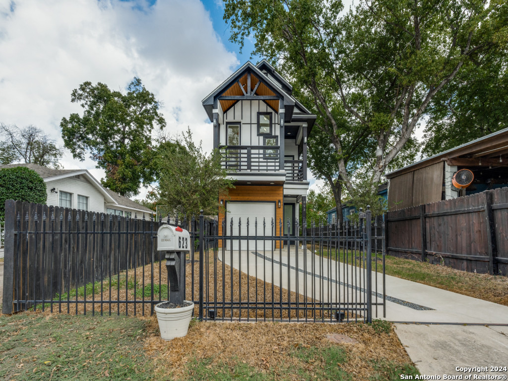 a front view of a house with a fence