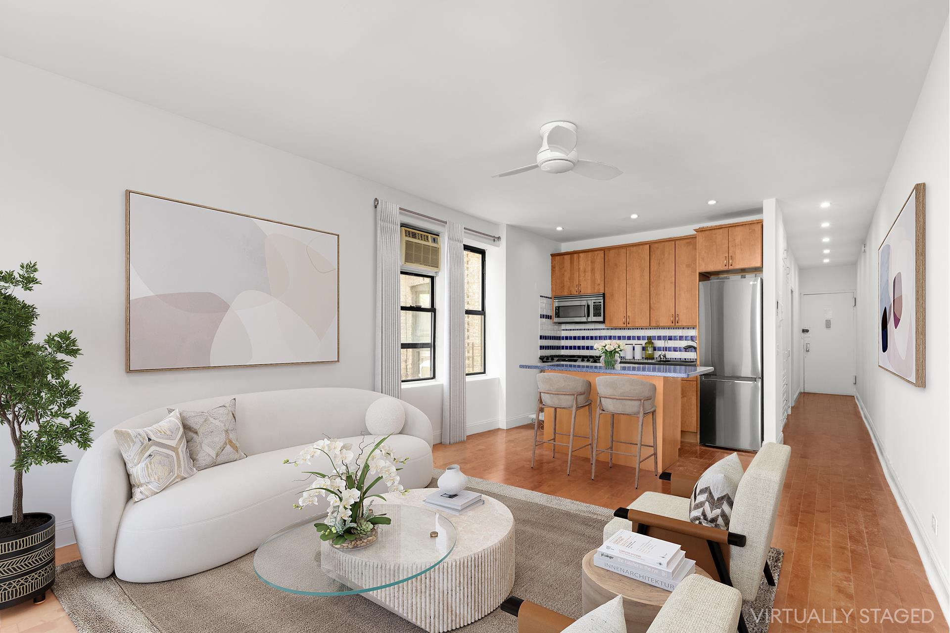 a living room with furniture and a dining table with kitchen view