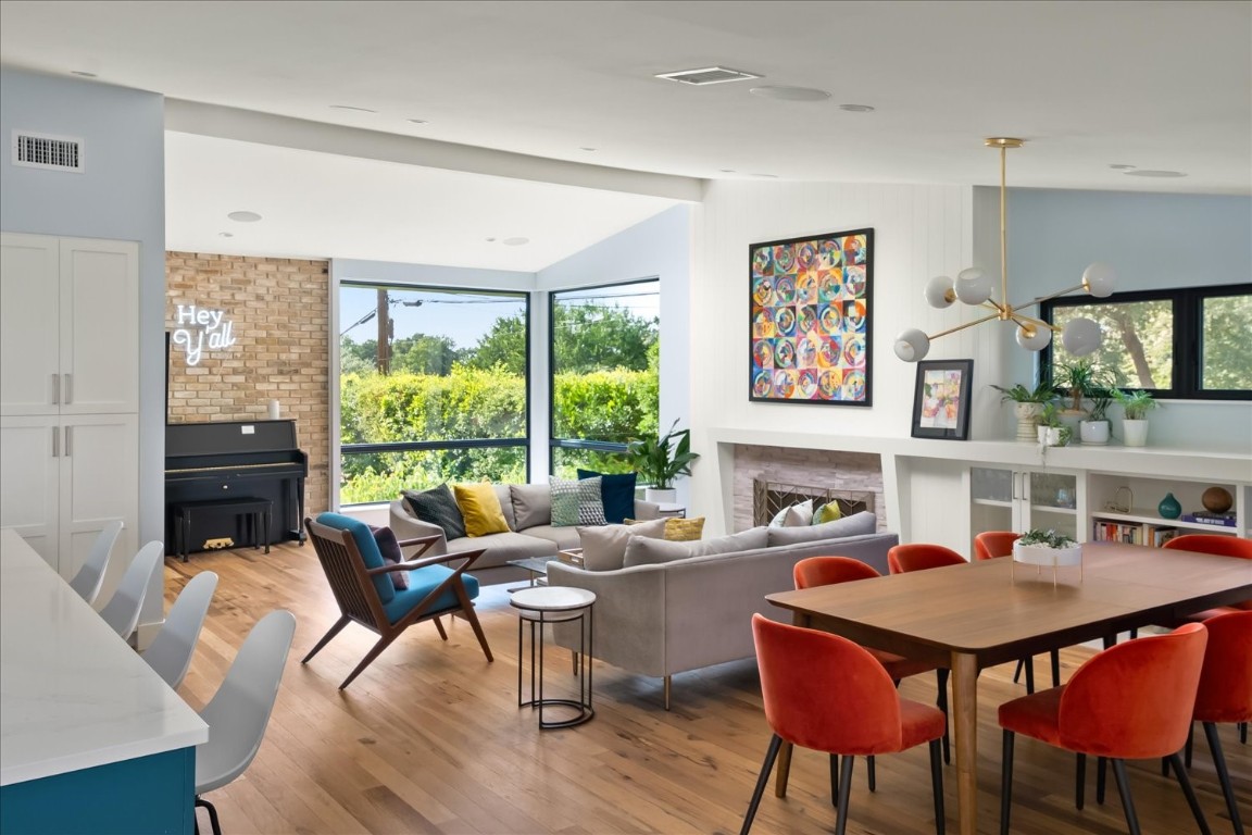 a dining room with furniture a window and wooden floor