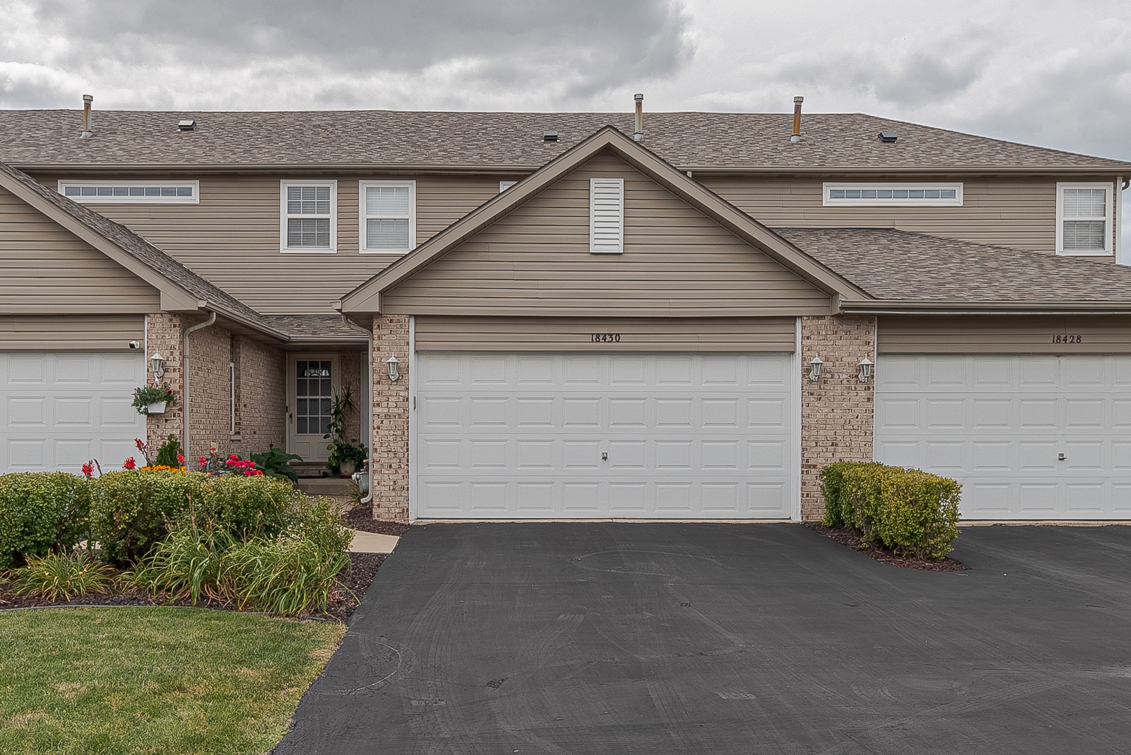 a front view of a house with a garage