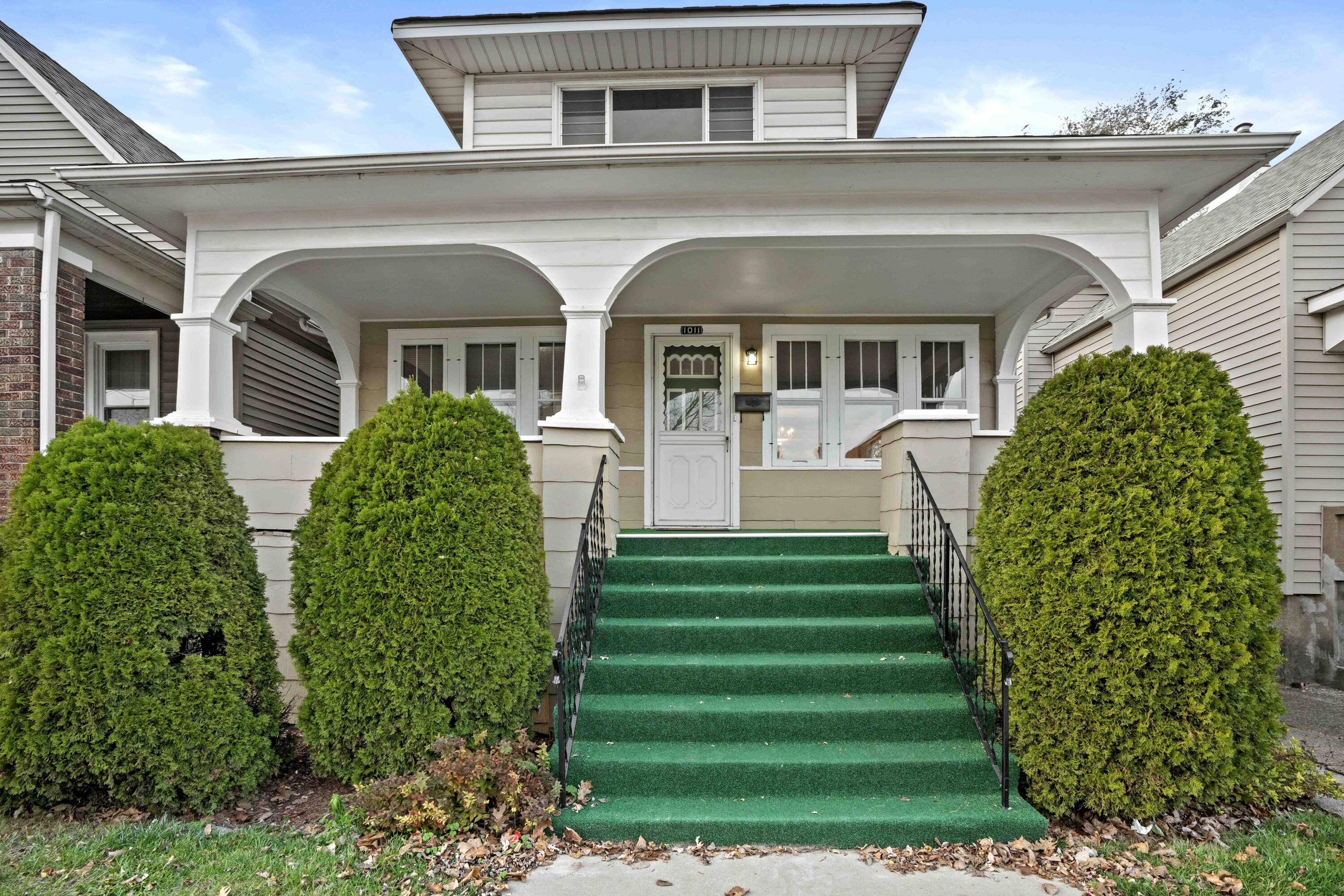 a front view of a house with a garden