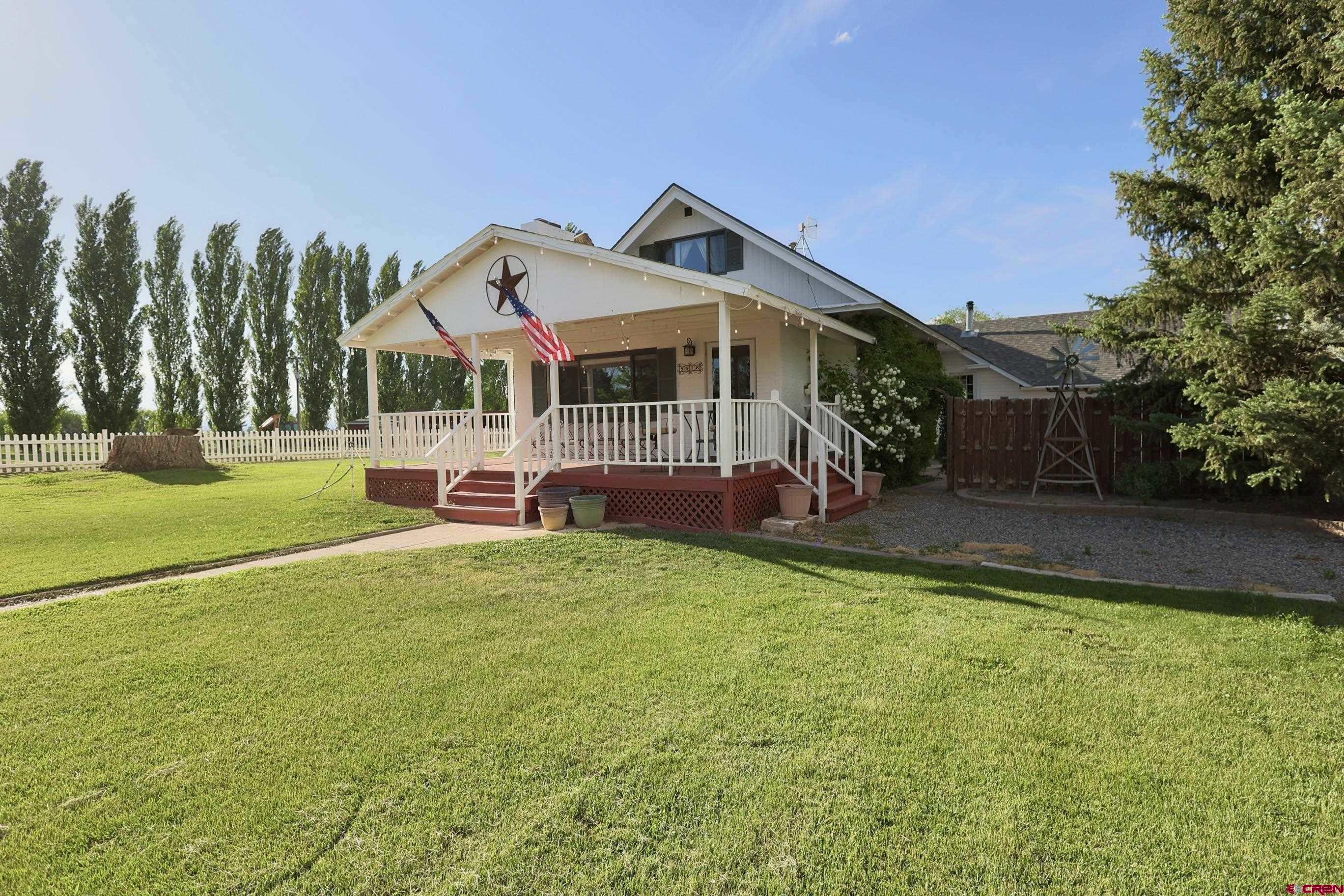 a front view of house with yard and trees