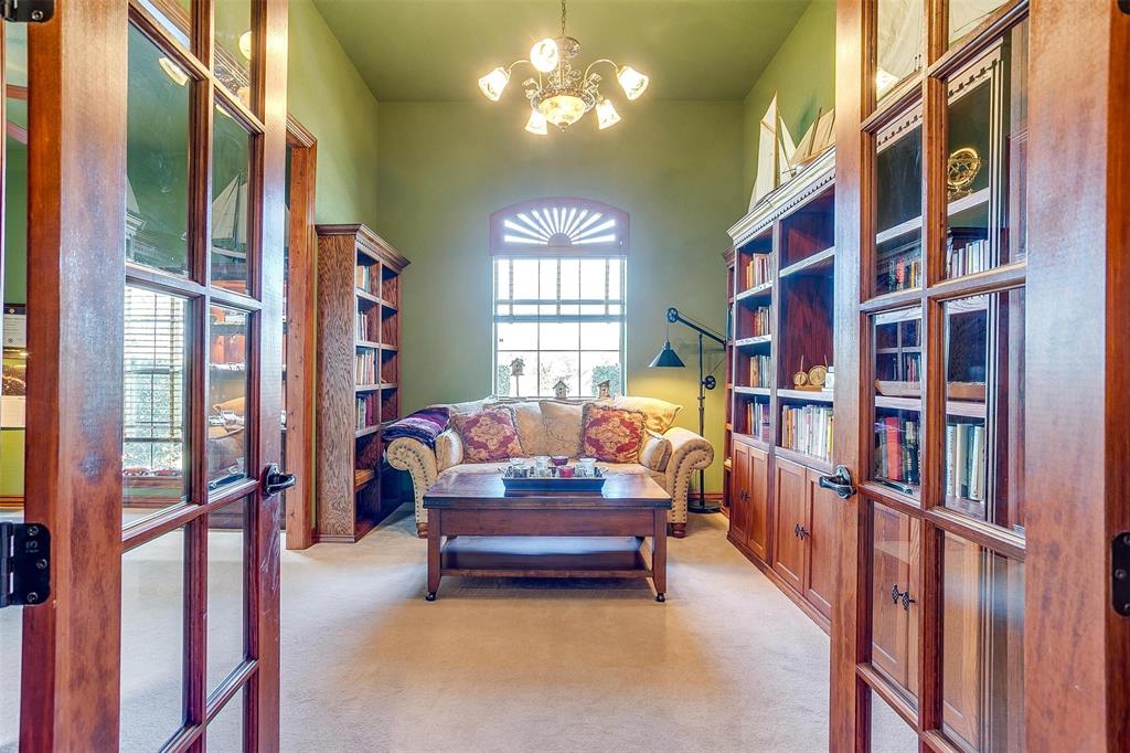 a living room with lots of furniture and a book shelf