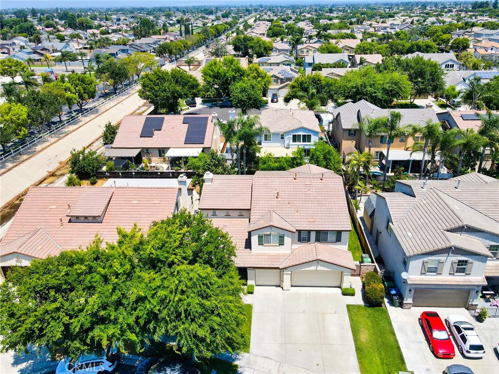 an aerial view of residential houses with outdoor space and parking