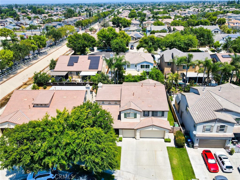 an aerial view of residential houses with outdoor space and parking