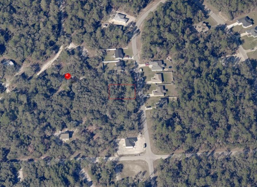 a aerial view of house with yard and mountain view in back