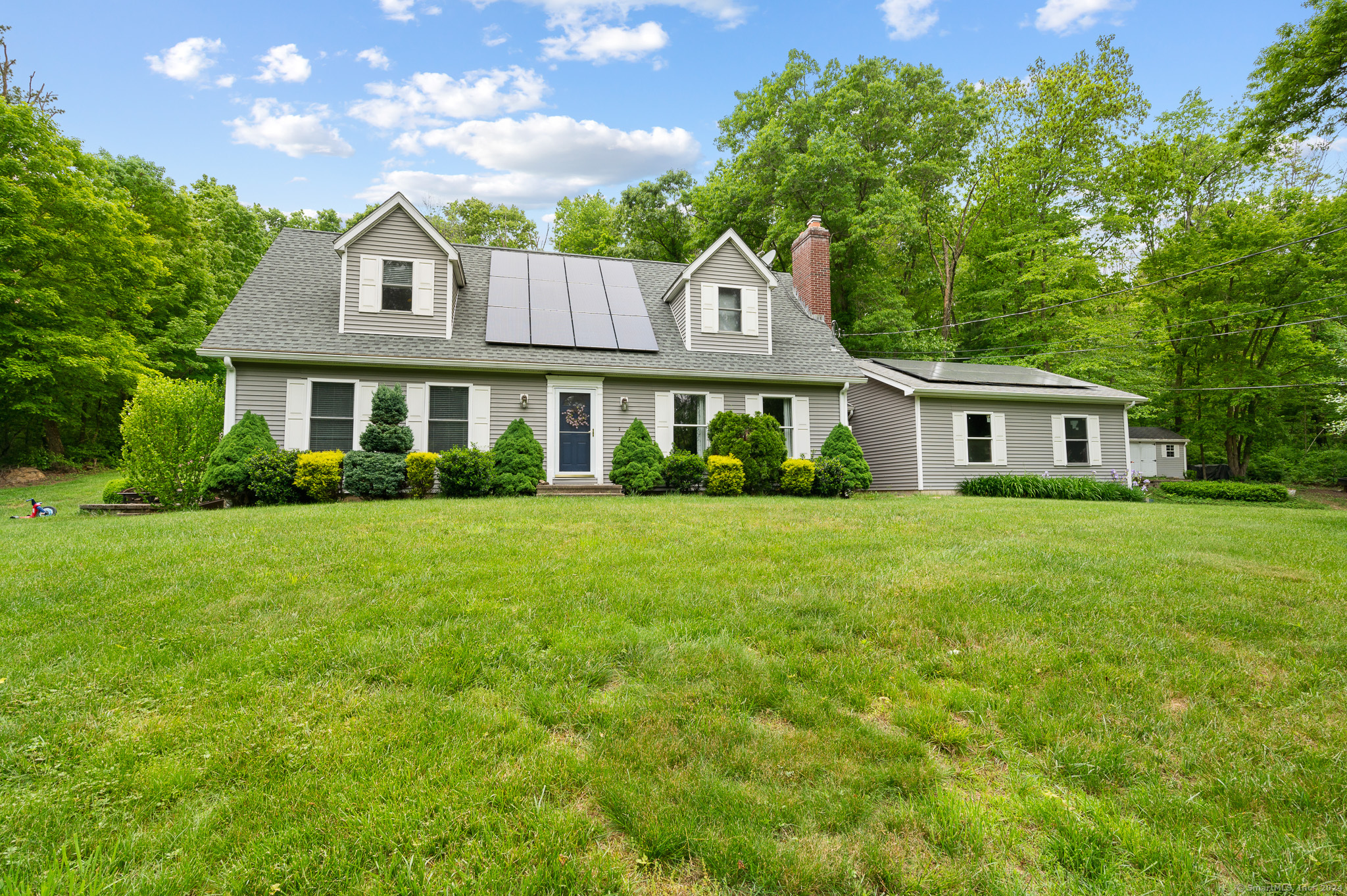 a front view of a house with a garden