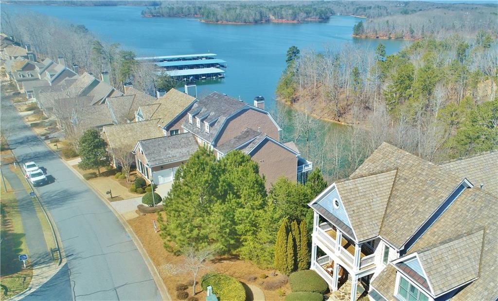 an aerial view of a house with a yard and lake view