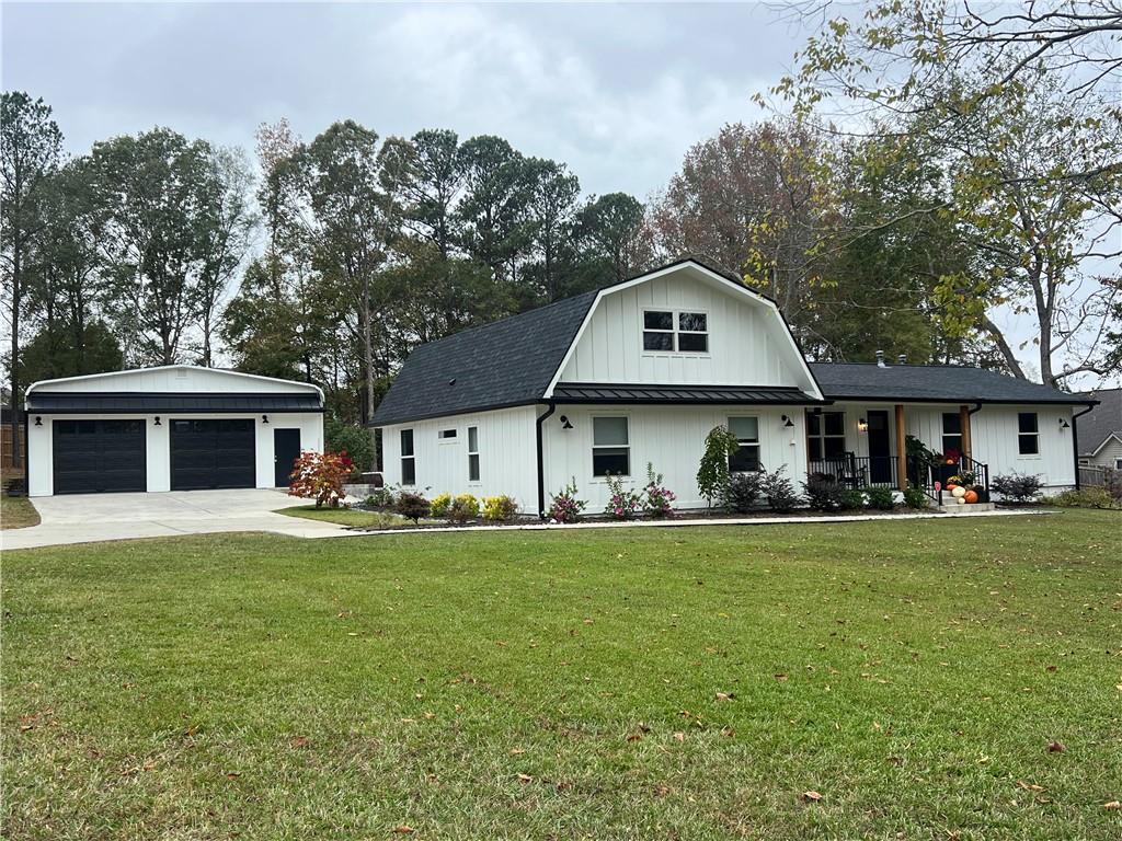 a front view of a house with a garden and trees