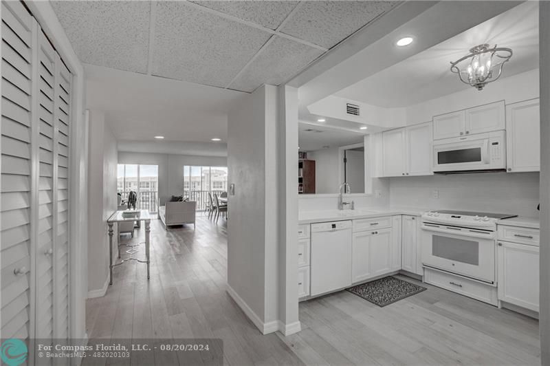 a open kitchen with sink and cabinets