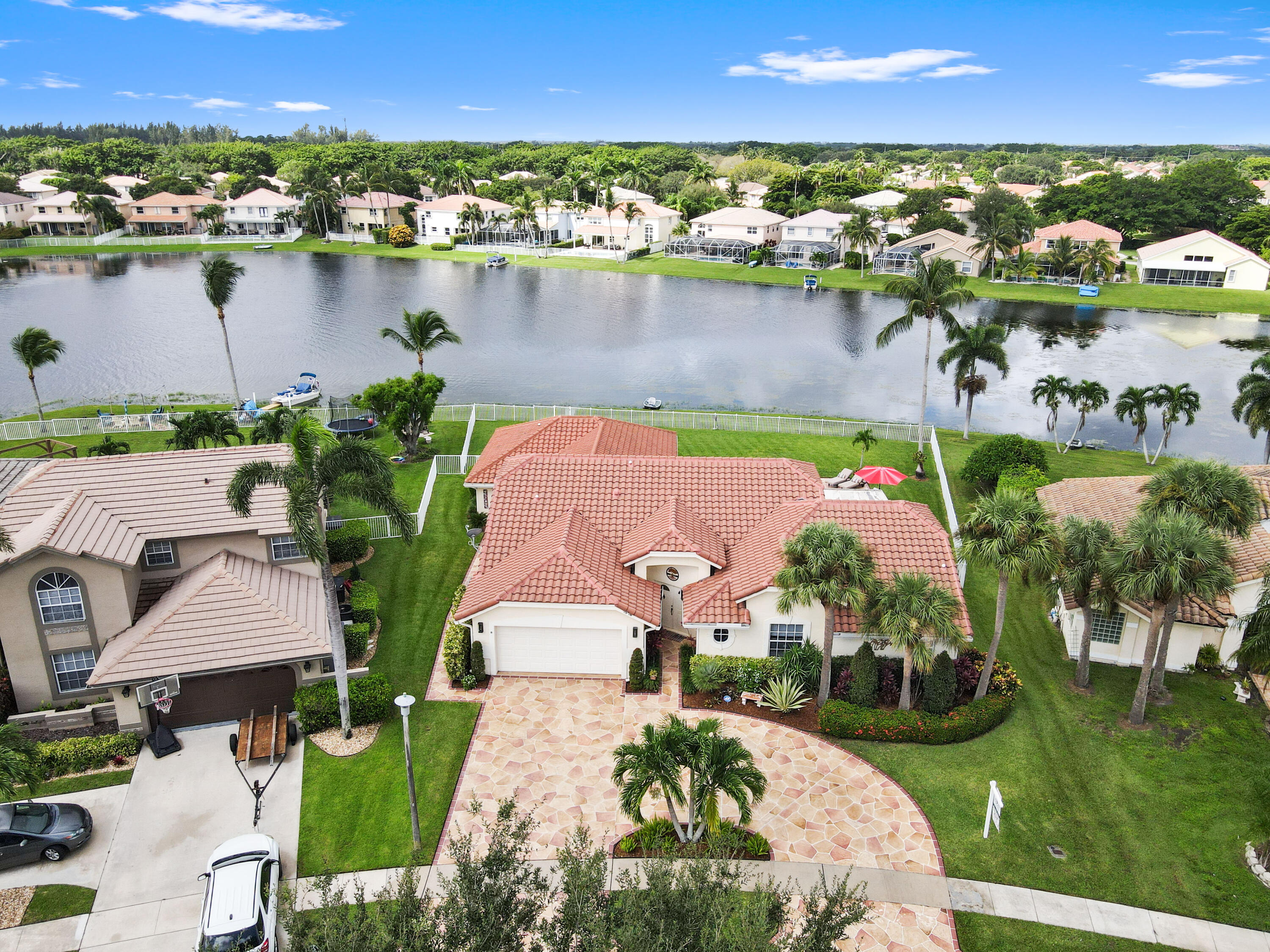 an aerial view of residential houses with outdoor space and lake view