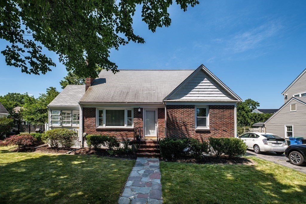 a front view of a house with a garden