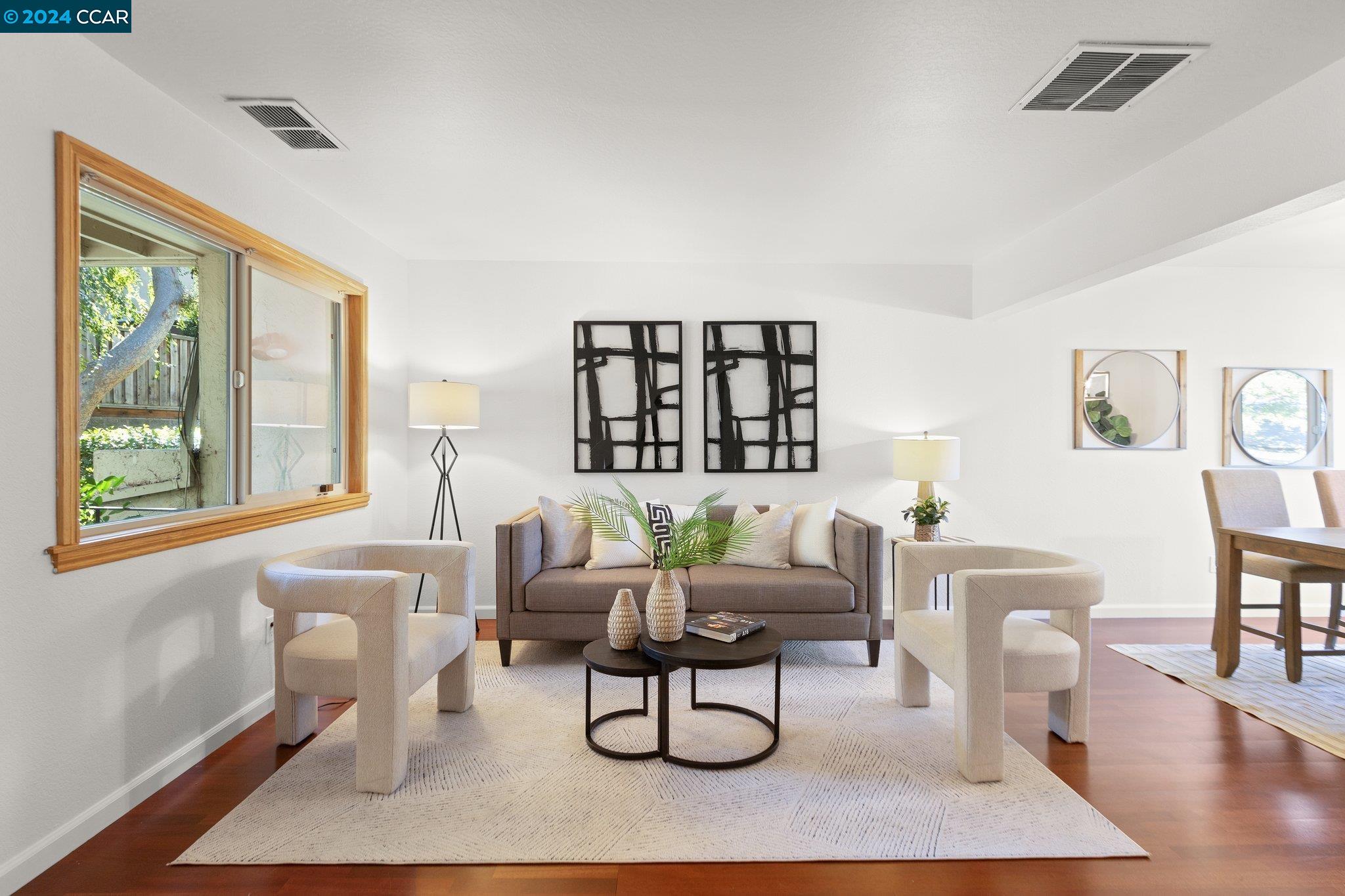 a living room with furniture a rug and a large window