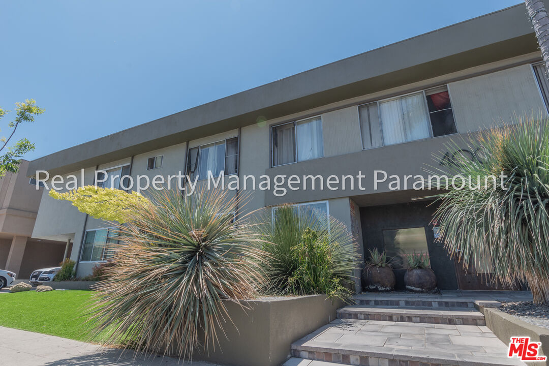 a building with potted plants in front of it