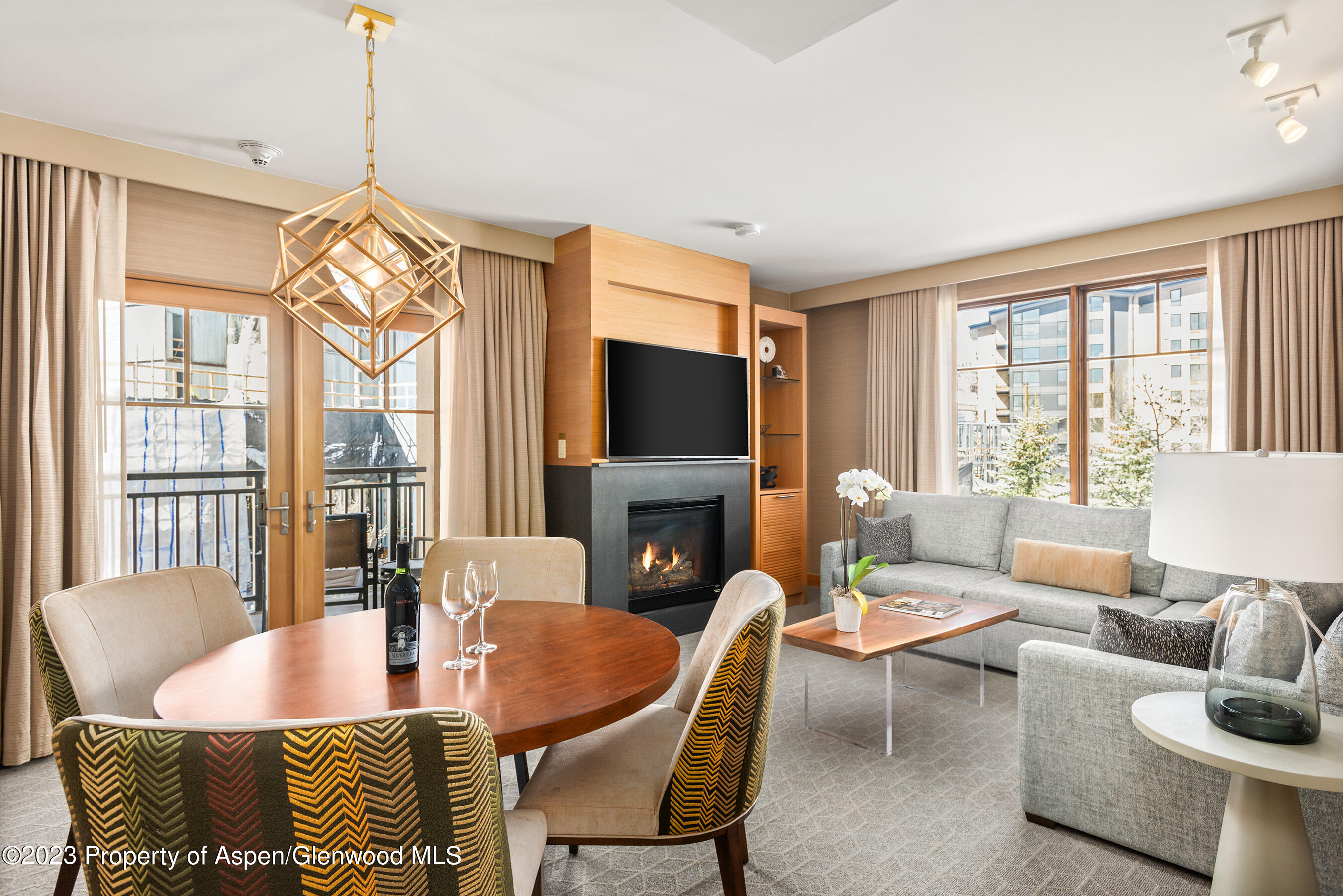 a living room with fireplace furniture and a large window