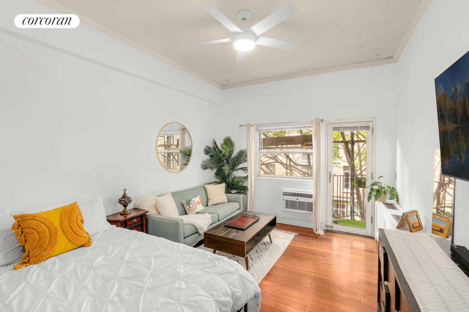 a bedroom with furniture and a large window