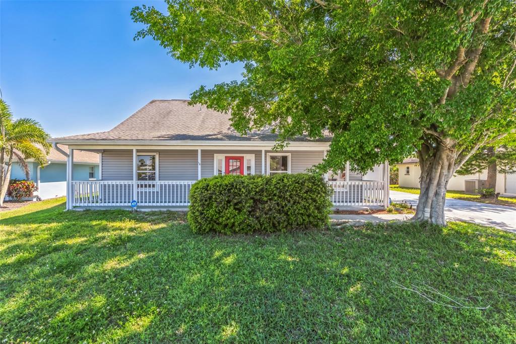 a view of house that has a yard