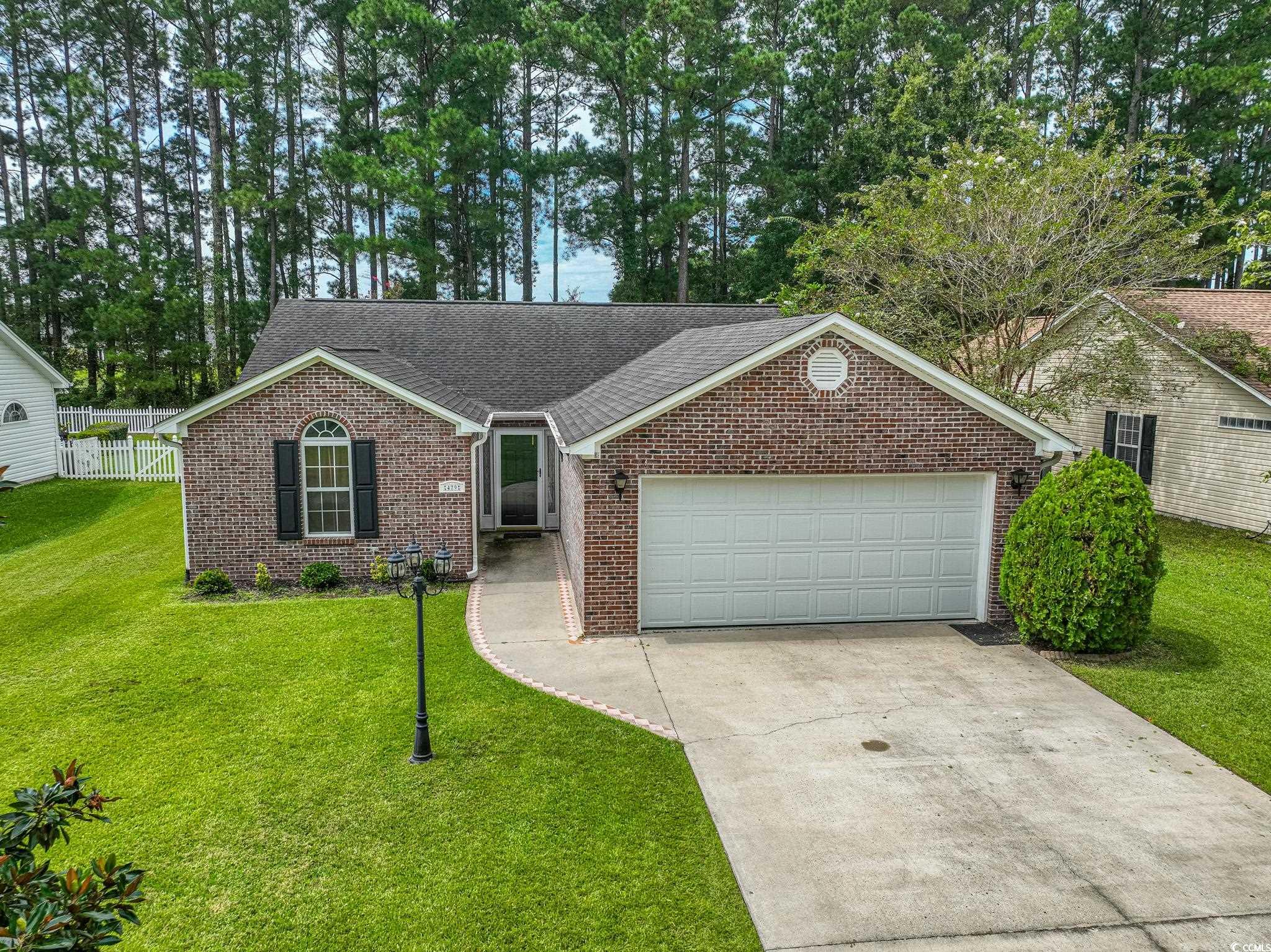 Ranch-style house with a garage and a front lawn