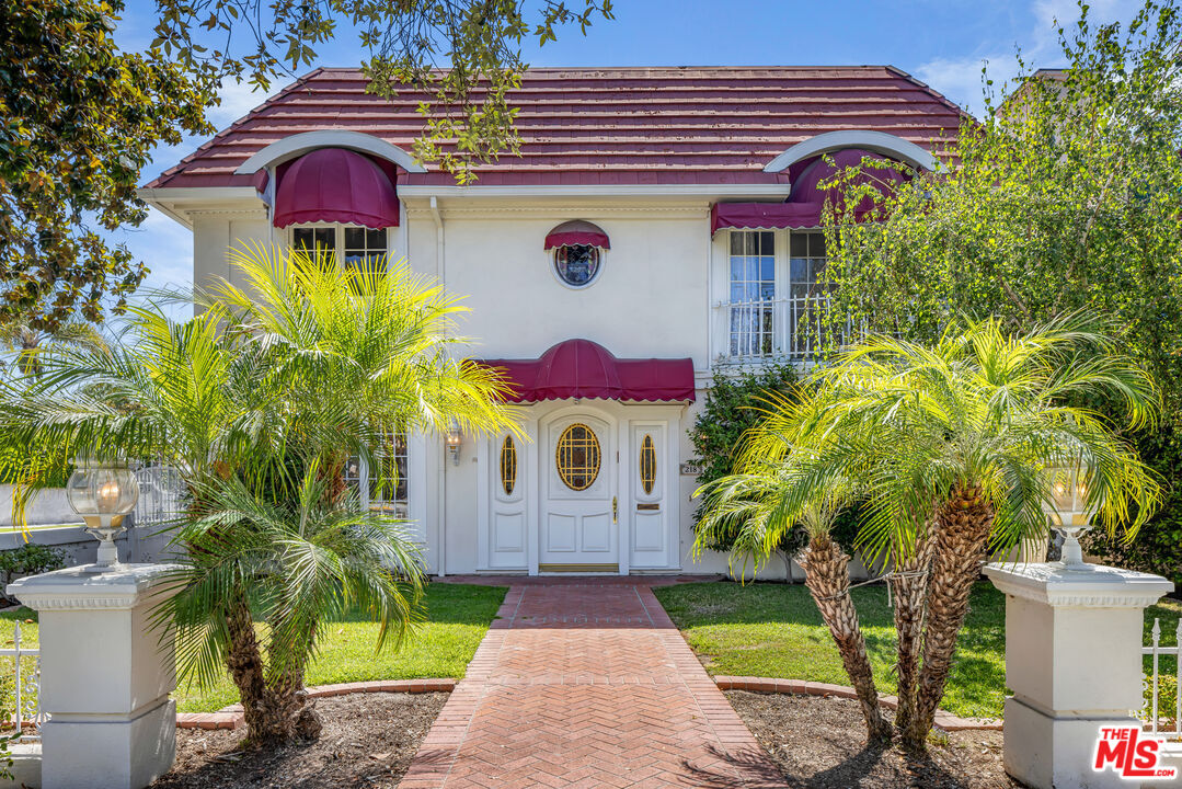 a front view of multi story residential apartment building with yard