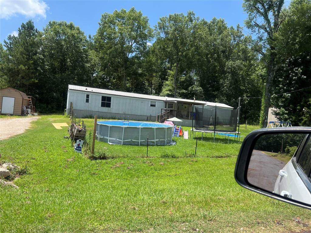 a view of a house with a backyard and a patio