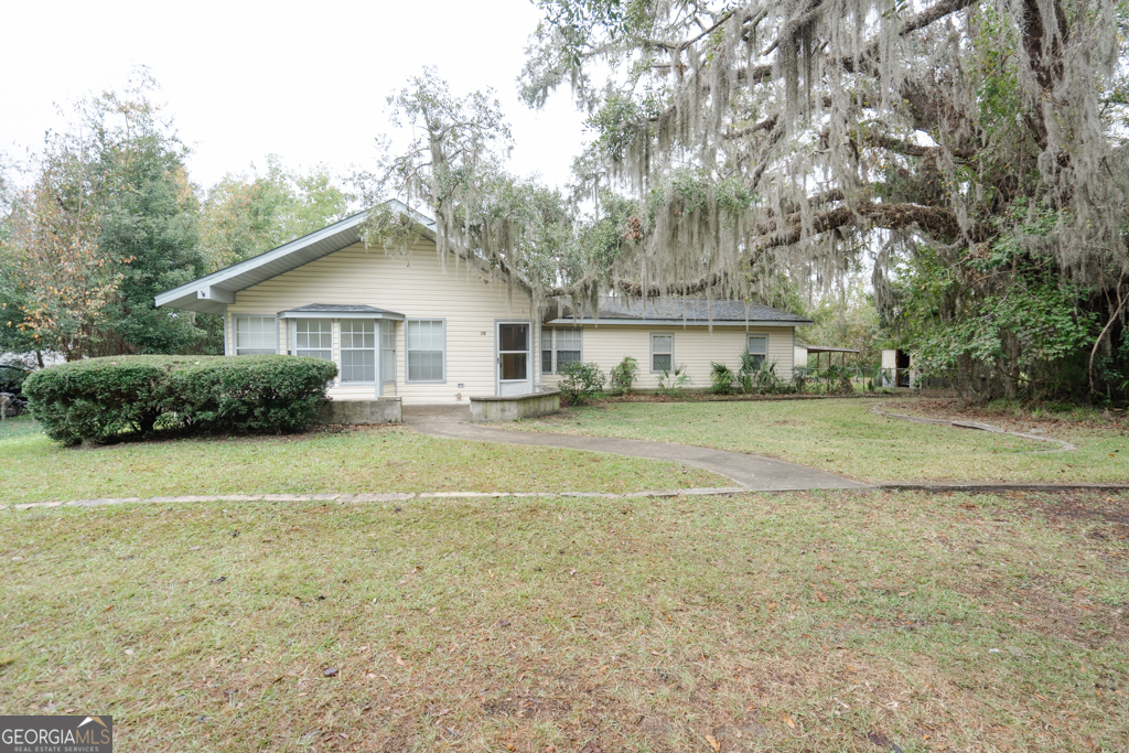 a front view of a house with a garden