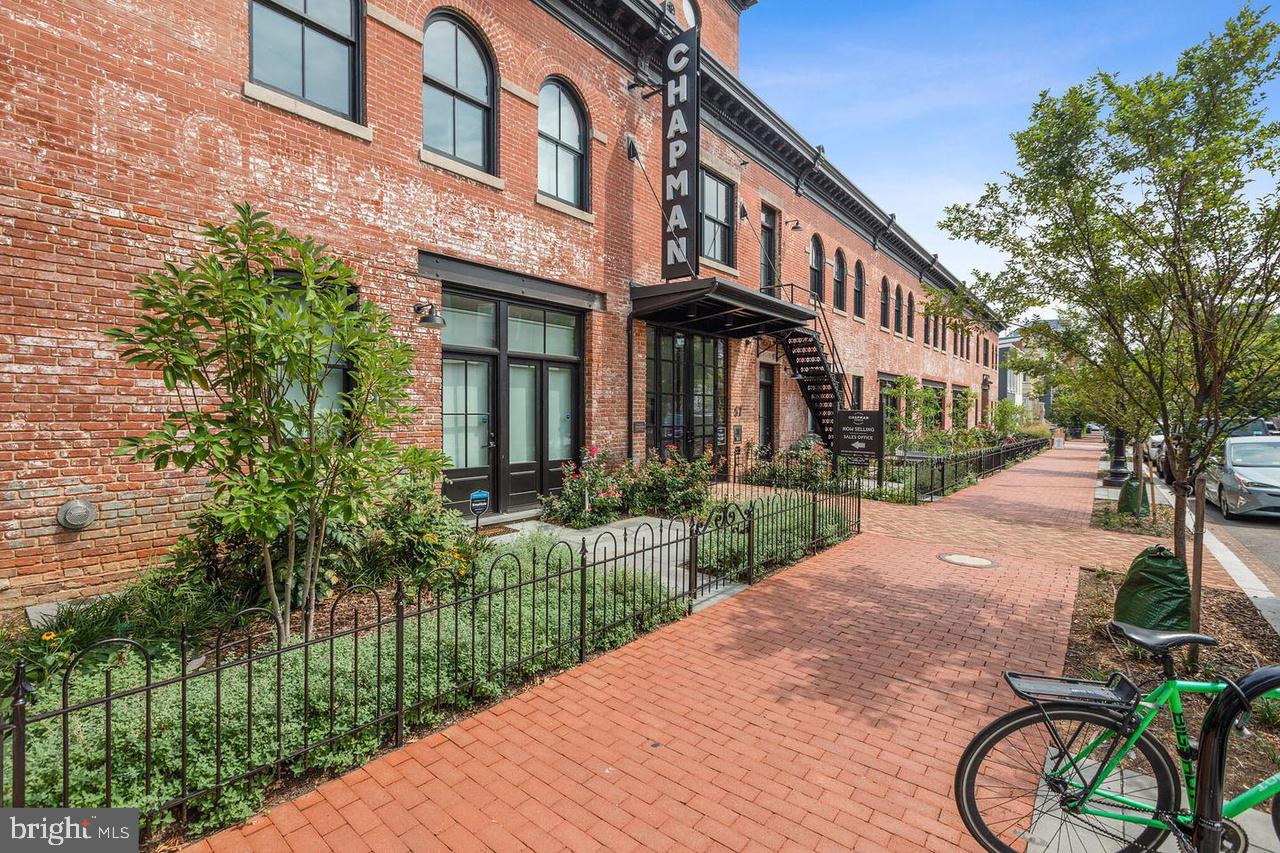 a view of a brick building next to a yard