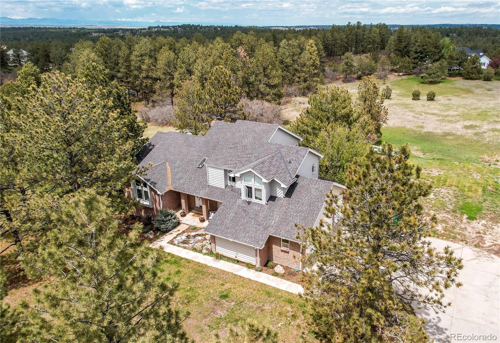 an aerial view of a house with a lake view