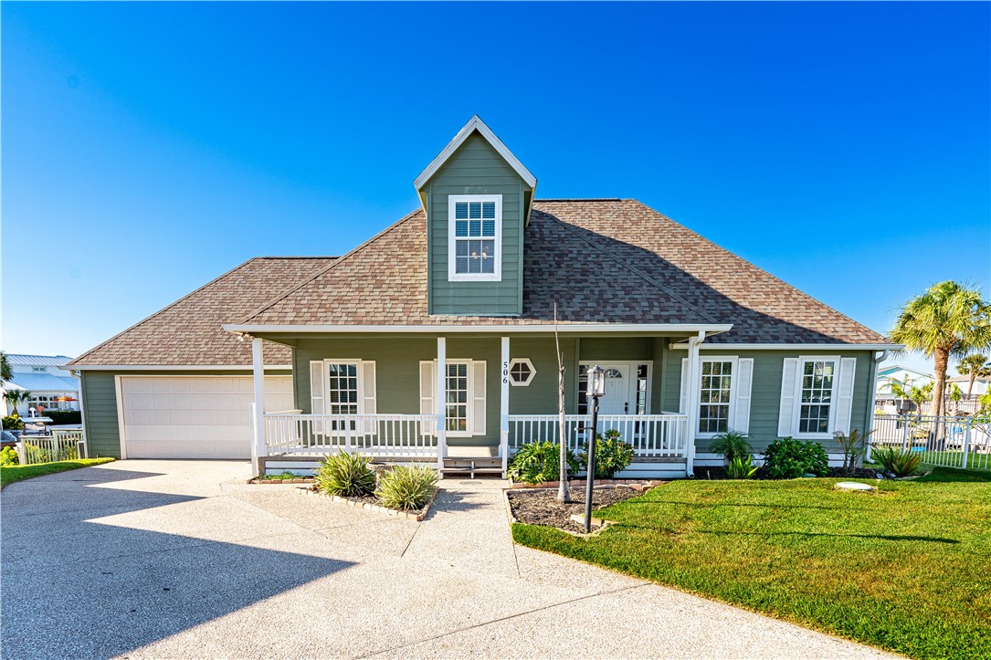 a front view of a house with a garden and yard